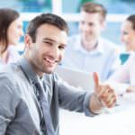Businessman showing thumbs up