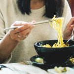 Woman Eating Tasty Noodle Restaurant Concept