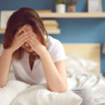 Unhappy girl in a bedroom