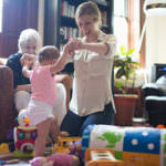 Mother helping daughter learn to walk