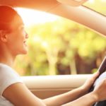 happy woman driver driving her car