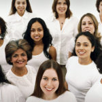 Studio Portrait of a Mixed Age, Multiethnic, Large Group of Happy Women Wearing White Tops