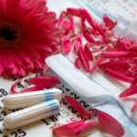 52133392 – sanitary pads, calendar, towel and pink gerber on light background