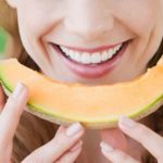 Woman-eating-a-slice-on-cantaloupe