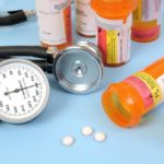 bottles-of-pills-with-a-stethoscope-and-blood-pressure-meter