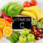 Foods High in vitamin C on a wooden board.