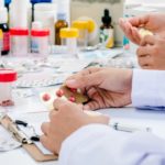 two pharmacists preparing medicine container in a pharmacy