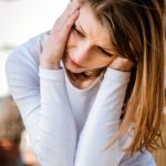 Young woman with headache outdoor