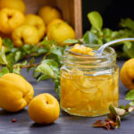 Syrup of japanese quince on fresh fruits background