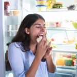 Close-up Of A Woman Eating Slice Of Cake