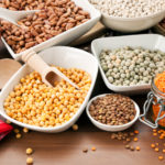 arrangement of various legumes in bowls on table