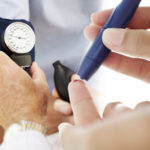 Pair of Human Hands Checking the Blood Pressure of a Patient