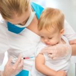 A doctor does injection child vaccination baby