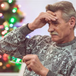 The old man feel headache near the christmas tree