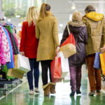 Family carrying shopping bags in mall