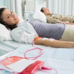 Smiling transfused patient next to another