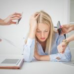 Woman overloaded with stuff at work