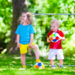 Children Playing Football Outdoors