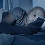 internet-addict-man-awake-at-night-in-bed-with-mobile-phone