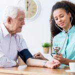 an-older-man-is-having-his-blood-pressure-measured-by-a-woman