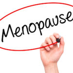 Man Hand Writing Menopause With Black Marker On Visual Screen.
