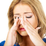 Beautiful young woman with sinus pressure pain.
