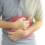 man-holding-his-stomach-in-pain