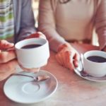 two-adults-drinking-coffee