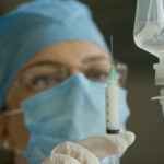 Doctor Preparing Anesthetic Syringe