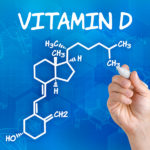 Hand with pen drawing the chemical formula of vitamin d