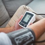 man-measuring-his-own-blood-pressure-with-band-and-monitor