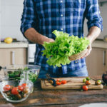 Man cooking summer salad home kitchen. Healthy food concept