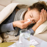 Sick Woman.Flu.Woman Caught Cold. Sneezing into Tissue. Headache