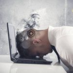 overworked-man-slamming-head-on-laptop-600×400