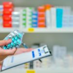 pharmacist-filling-prescription-blur-pharmacy-drugstore_67340-189