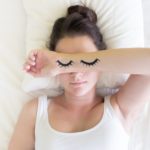 young-person-sleeping-with-eyelids-drawn-on-her-arms