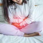 woman have bladder pain sitting on bed in bedroom after wake up feeling so sick and painful,Healthcare concept