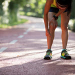 Female runner suffering with pain on sports running knee injury