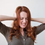 woman-with-misophonia-covering-her-ears-because-she-is-upset-by-noises