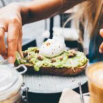 young-woman-eating-egg-avocado-bread-thumb