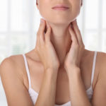 Close up of female neck and shoulders. Woman thyroid gland control.