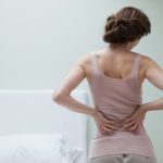 Woman rubbing aching back