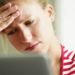 woman having headache with hands on temple. Copy space