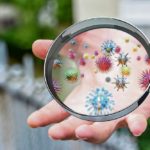 2066067_stockphotocloseuponasickmanhandthroughmagnifyingglasstransmittingvirusbyskincontactdrendering500172949_ls