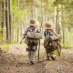 Boys on a forest road with backpacks