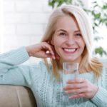 1831659_stockphotobeautifulmiddleagedwomandrinkingwaterinthemorningwomansfacecloseup1029888280_ls