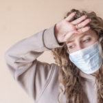 Portrait of sick girl in medical mask with headache symptom. Coronavirus infectious. Copy space