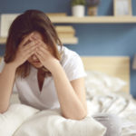 Unhappy girl in a bedroom