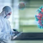 Scientist in clean suit researching coronavirus in laboratory