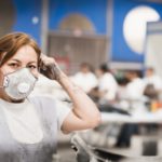 Worker wearing face mask in manufacturing plant